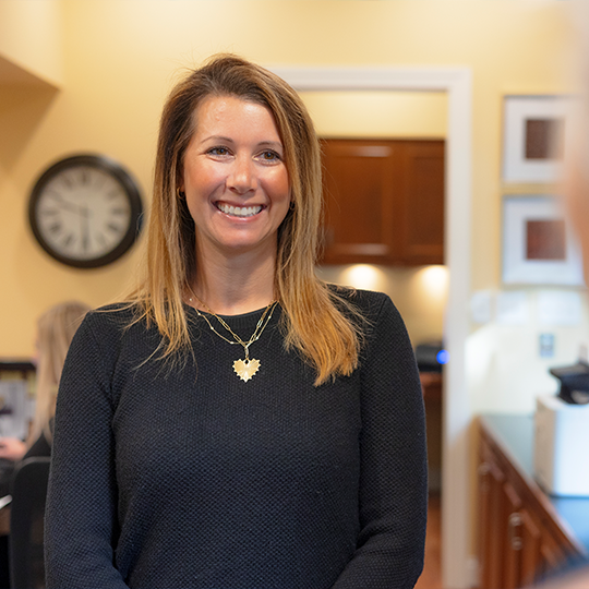 Dental team member smiling at a patient