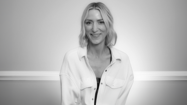Smiling blonde woman in a white jacket