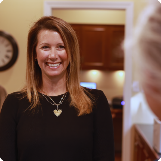 Dental team member grinning at a patient